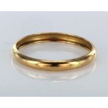 Yellow metal bangle (tests as over 18ct) approx 74mm diameter, weight 22.5g