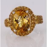 18ct white gold dress ring set with central oval chequerboard cut citrine, surrounded by pave set