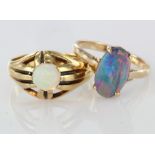 Two rings to include an 18ct yellow gold opal set flared band ring, finger size P, weight 4.9g. A