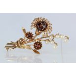 9ct rose gold floral spray brooch set with garnets and pearls, weight 8.9g