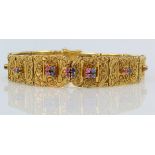 18ct yellow gold solid panelled bracelet with filigree decoration and each panel set with sapphire