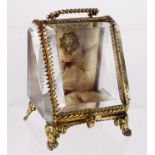 Gilt metal pocket watch display case, circa late 19th to early 20th Century, raised on four feet