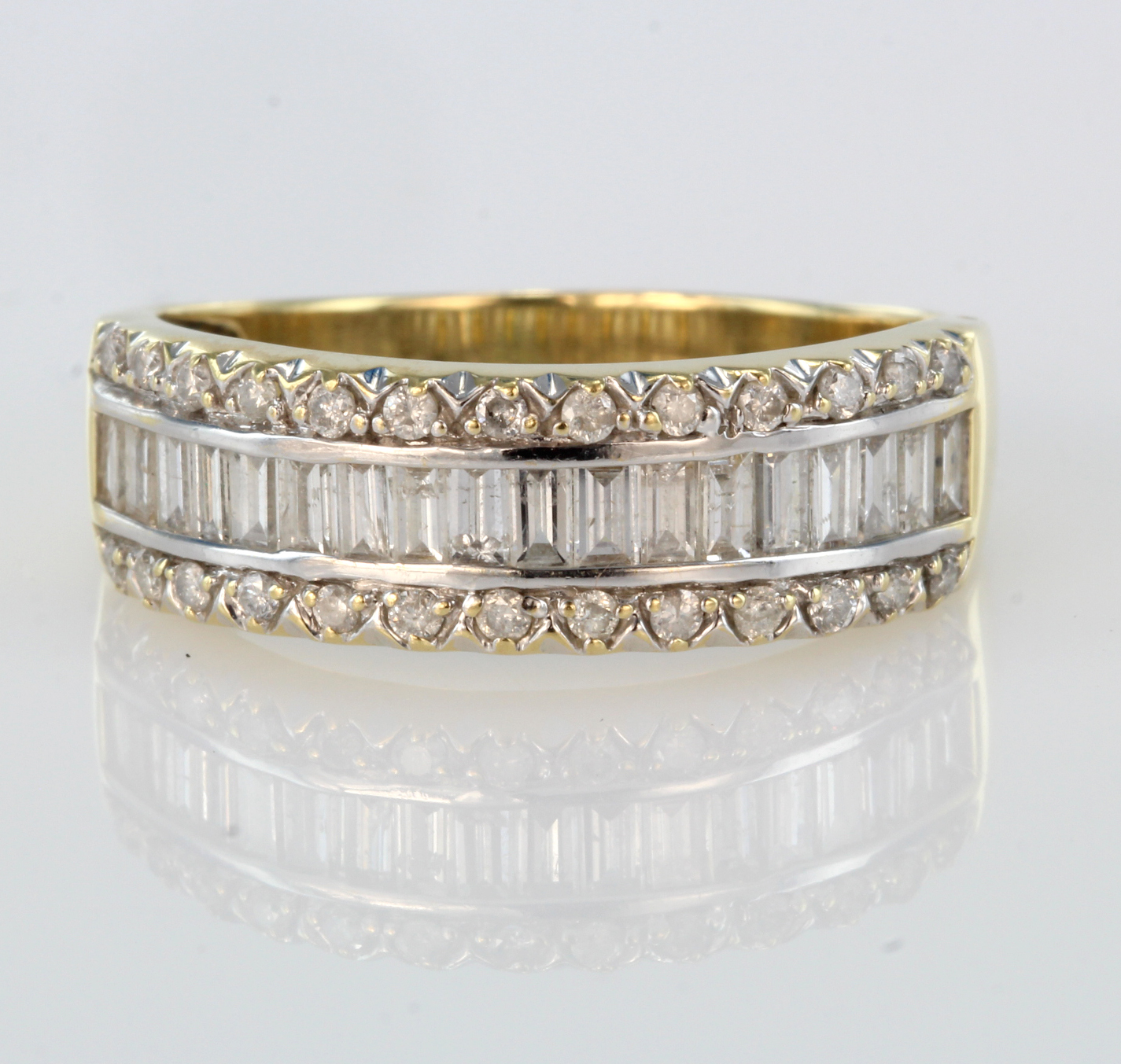 18ct yellow gold band ring set with row of baguette cut diamonds bordered by a row of round diamonds