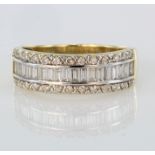 18ct yellow gold band ring set with row of baguette cut diamonds bordered by a row of round diamonds