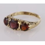 9ct yellow gold graduated three stone garnet ring, finger size L, weight 2.1g