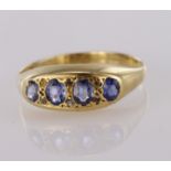 18ct yellow gold graduated sapphire four stone ring with diamond points, finger size P, weight 2.6g