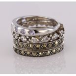 Set of four stacking rings to include two silver and marcasite rings, a silver cz ring and a 9ct