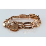 9ct rose gold three-bar gate bracelet with safety catch. Aprox 16.4g