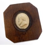 Plaster (?) portrait plaque of a gentleman, circa late 19th Century, mounted in an oak frame,