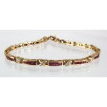 9ct yellow gold bracelet with four panels of princess cut channel set rubies separated by diamond