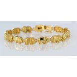 18ct yellow gold bracelet featuring alternate satin and polished elephants with box clasp and safety