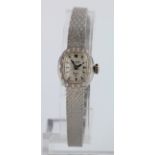 Boxed Ladies 14ct cased Christiam Dior by Bulova wristwatch on an integral 14ct white gold bracelet,