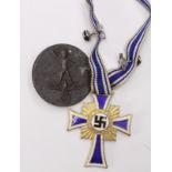 German Mothers Cross in gold, in fitted correct case, plus a mothers day badge & unusual swastika