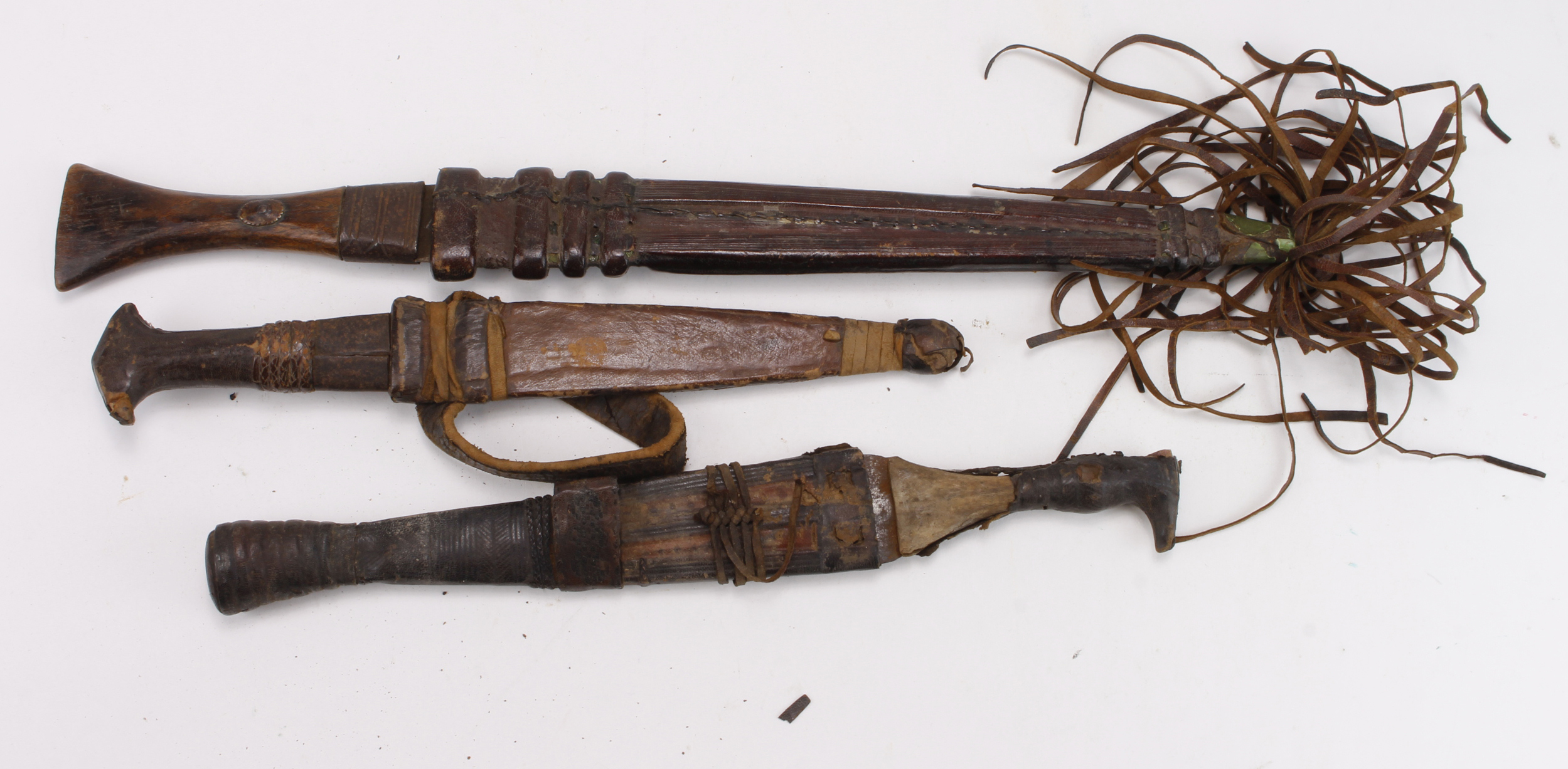 African Tribal knives, leaf shaped blades, leather scabbards, surface rust to blades. Nice lot worth