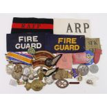 Shoebox of various cap badges, buttons, ARP badges, metal and cloth. Including British, Irish,