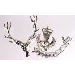 Badge: Queen's Own Highlanders (KK2052) Officer’s silver plated 3-part cap badge. The badge is in