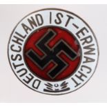 German Nazi enamelled badge 'Deutschland 1st - Erwacht'. Marked 'Ges Gesch' on the reverse. (5cm)