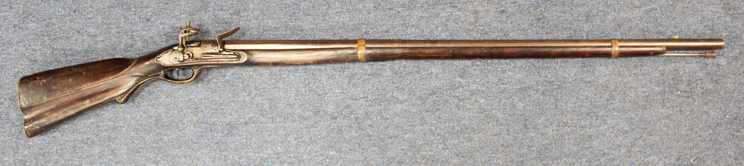 18th century flint lock musket with caved stock, brass furniture unusual gun.