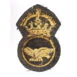 Badge an early RAF or RNAS cap badge, yellow thread, service worn.