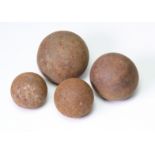 19th century cannon balls four of various sizes.