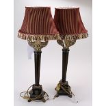 A pair of ornate Buffet style lamps with carved wooden stands and four-footed bases. Along with pale