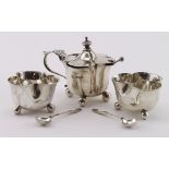 Composite three piece silver cruet set comprising a mustard pot, two later Salts with three salt