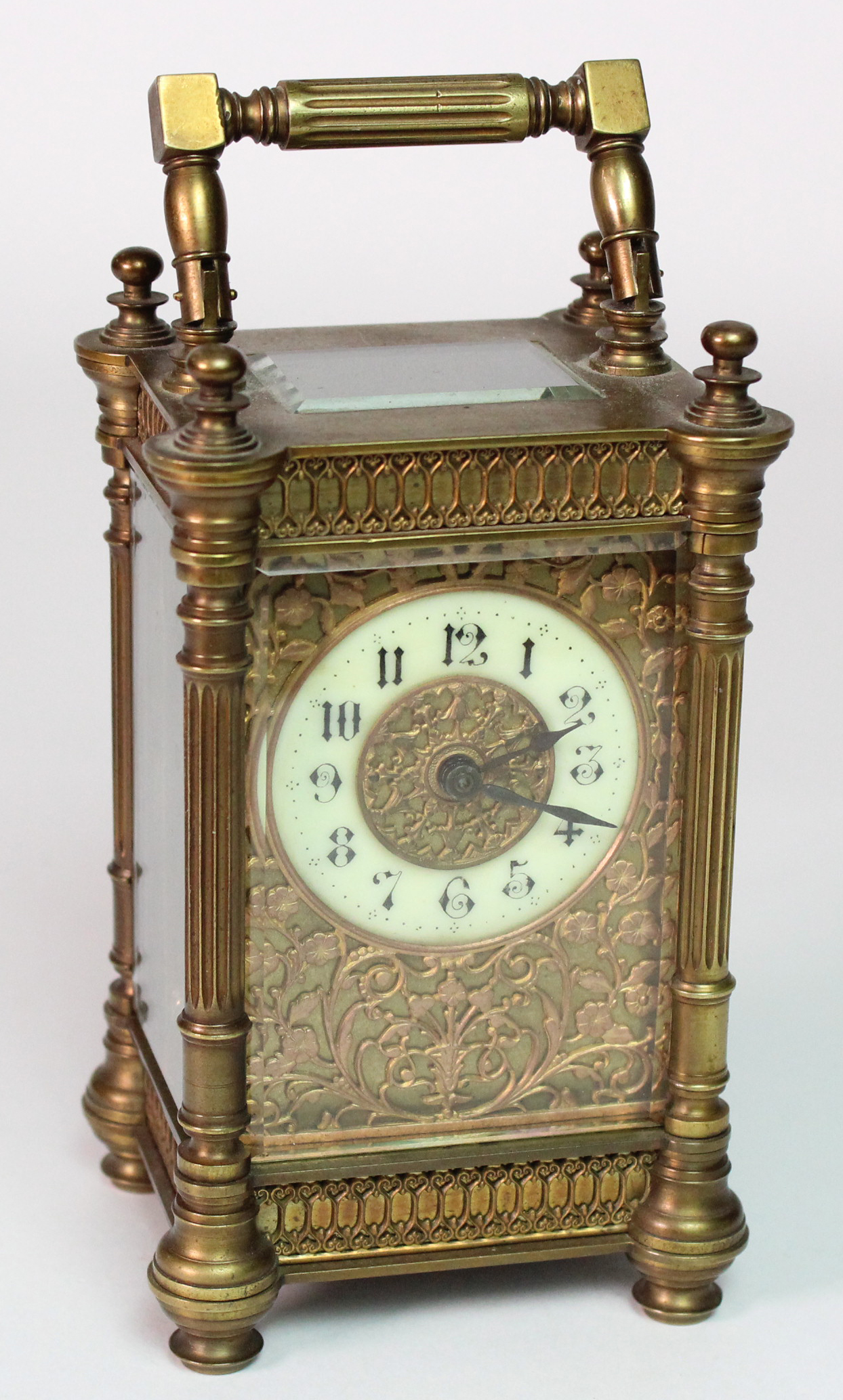 Brass five glass carriage clock, enamel dial with Arabic numerals, surrounded by foliage filigree
