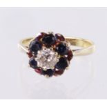 18ct gold ring with central approx 0.4ct diamond surrounded by six sapphires. Size L weight 3.2g