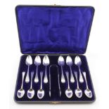 Composite set of twelve Georgian silver teaspoons and silver sugar tongs in a fitted box - six