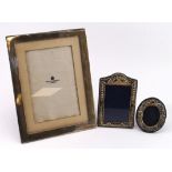 Three silver hallmarked photograph frames, largest by Mappin & Webb, measures 17cm x 22cm approx.