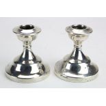 Pair of matching silver dwarf candlesticks hallmarked Birmingham, 1951 and 1956; Retailer J.