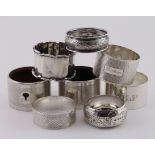 Six silver napkin rings and two silver & wood napkin rings, various dates and hallmarks; the
