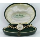 Ladies 9ct cased Rolex wristwatch, on a 9ct bracelet. In its original box with guarantee dated 19/