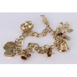 9ct Gold Charm Bracelet set with eight charms and Padlock weight 18.9g