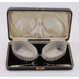 Boxed pair of silver & glass butter dishes and two silver butter forks, hallmarked A. Bros. Ltd.