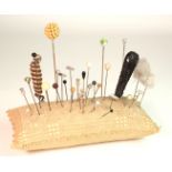 Hat Pins. Over thirty various hat pins, all contained in a contemporary pin cushion, longest 17cm