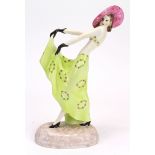 Porcelain figure, depicting a stylish Art Deco female wearing a green floral dress and hat, marked