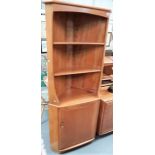 Ercol pale elm floorstanding corner cabinet with two shelves over a cupboard door, height 179cm.