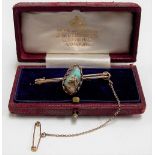 9ct hallmarked gold boulder opal set bar brooch with safety chain, the irregular shaped opal with