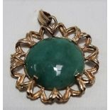 Yellow metal mounted green jade cabochon pendant, with suspension ring, diameter 30mm, weight 6.4g