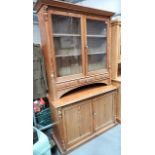 Victorian pitch pine dresser, the pair of glazed doors enclosing two shelves and with three short
