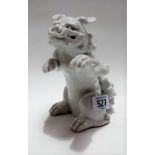 Chinese blanc De Chine incense burner in the form of a seated Fo dog with front paws outstretched,