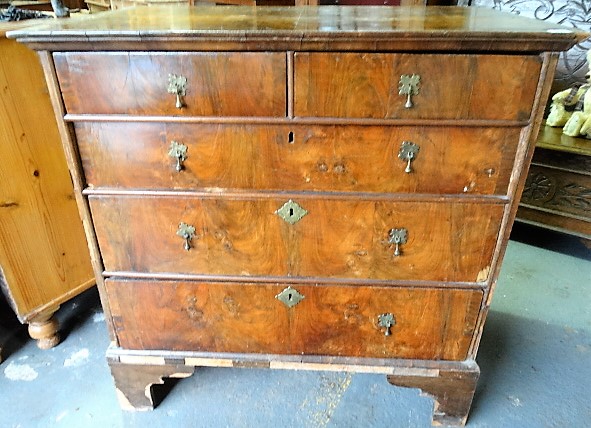 Early 18th Century mahogany veneered chest of two short over three long graduated drawers upon