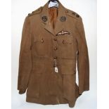 A British Officer's green tunic, applied with two Cornwall Light Infantry badges to the lapels,
