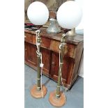 Pair of brass floorstanding oil lamps (converted) with white opaque glass ovoid shades and on