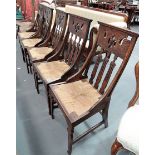 Set of five oak Arts & Crafts dining chairs, the top rail pierced over three shaped and pierced