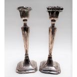 Pair of Edwardian silver square tapering section weighted candlesticks, both with damages, Chester