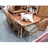 Ercol pale elm rectangular extending dining table with two extra leaves; together with a set of