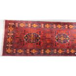 An Eastern wool hand knotted runner with four central medallions with foliate geometric borders upon