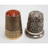 Continental gold thimble set with Carnelian top and with stiff leaf border, stamped marks, weight